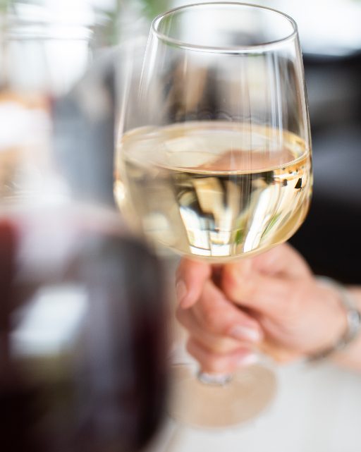 Two glasses of wine raised in a toast