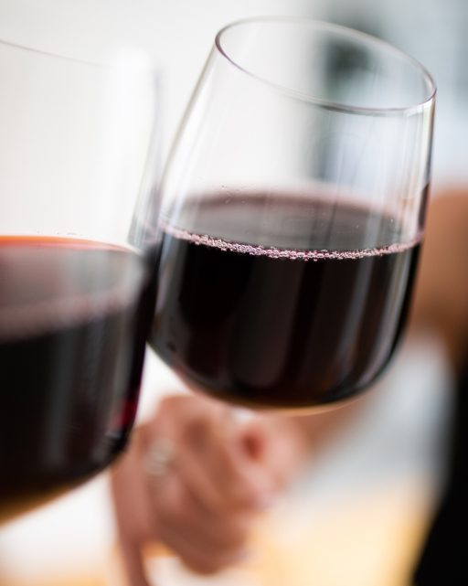 Two glasses of red wine clinking