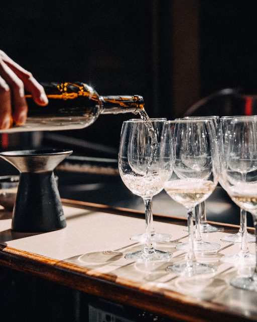 Wine being poured into glasses at the bar